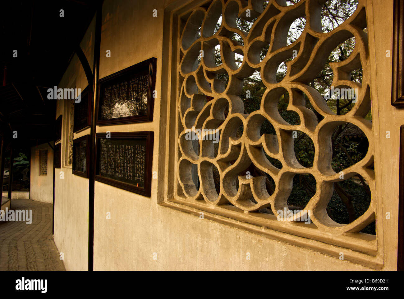 Framed Chinese writings and stone latticework window decoration Garden of the Humble Administrator from the Ming Dynasty Stock Photo