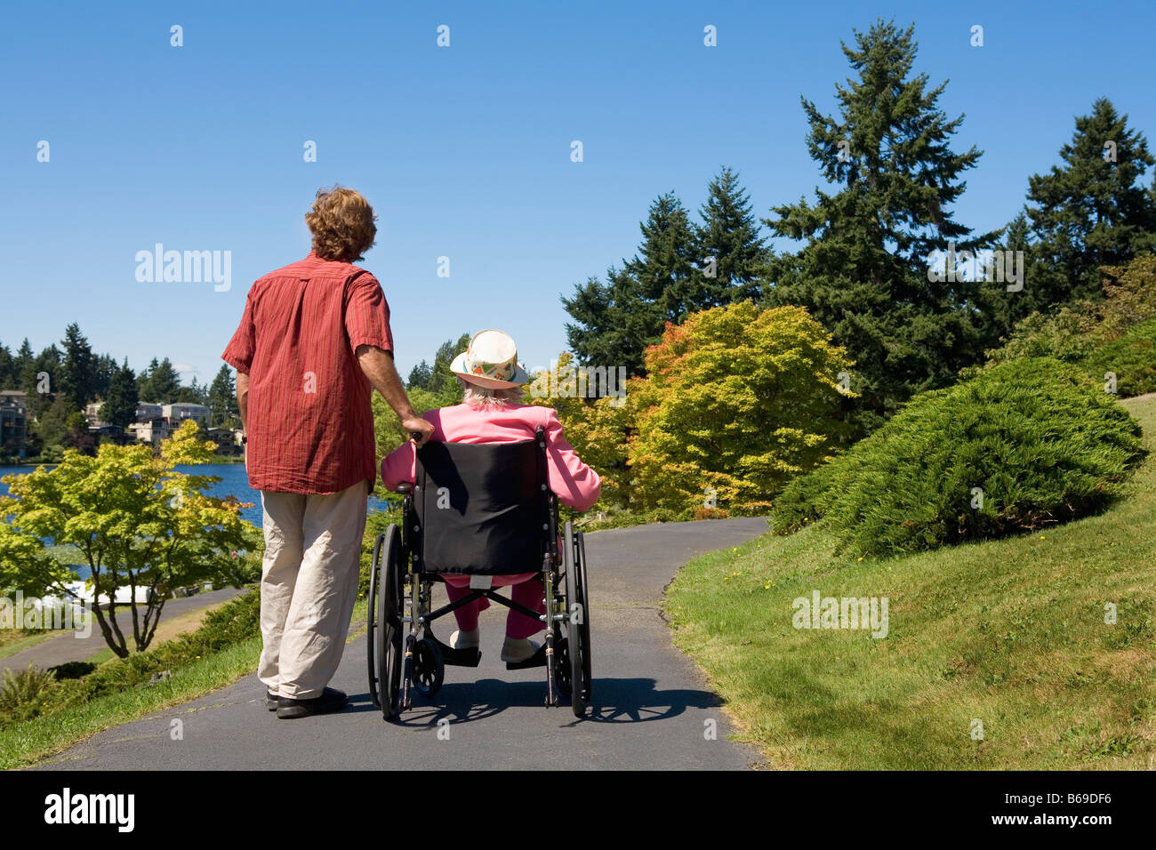 Man assisting his disabled mother in a wheelchair Stock Photo Alamy
