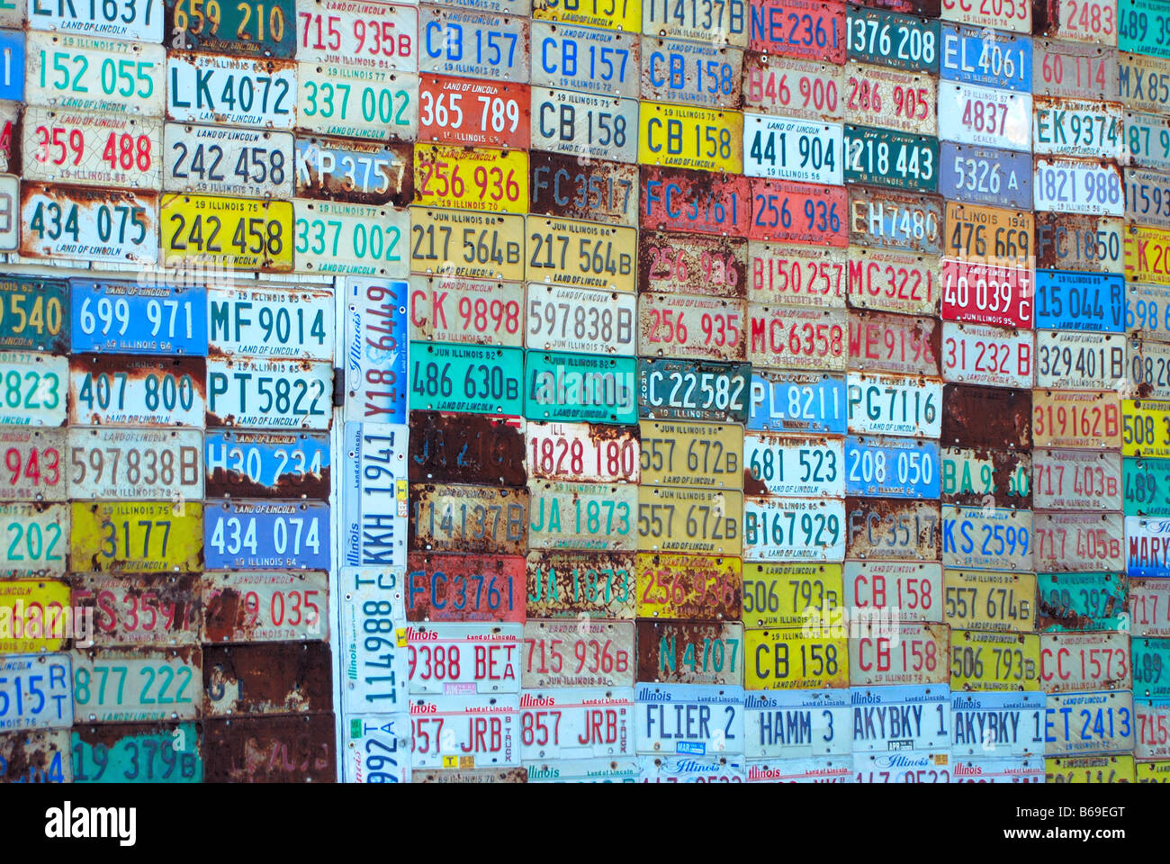 Old license plates on a garage wall Stock Photo
