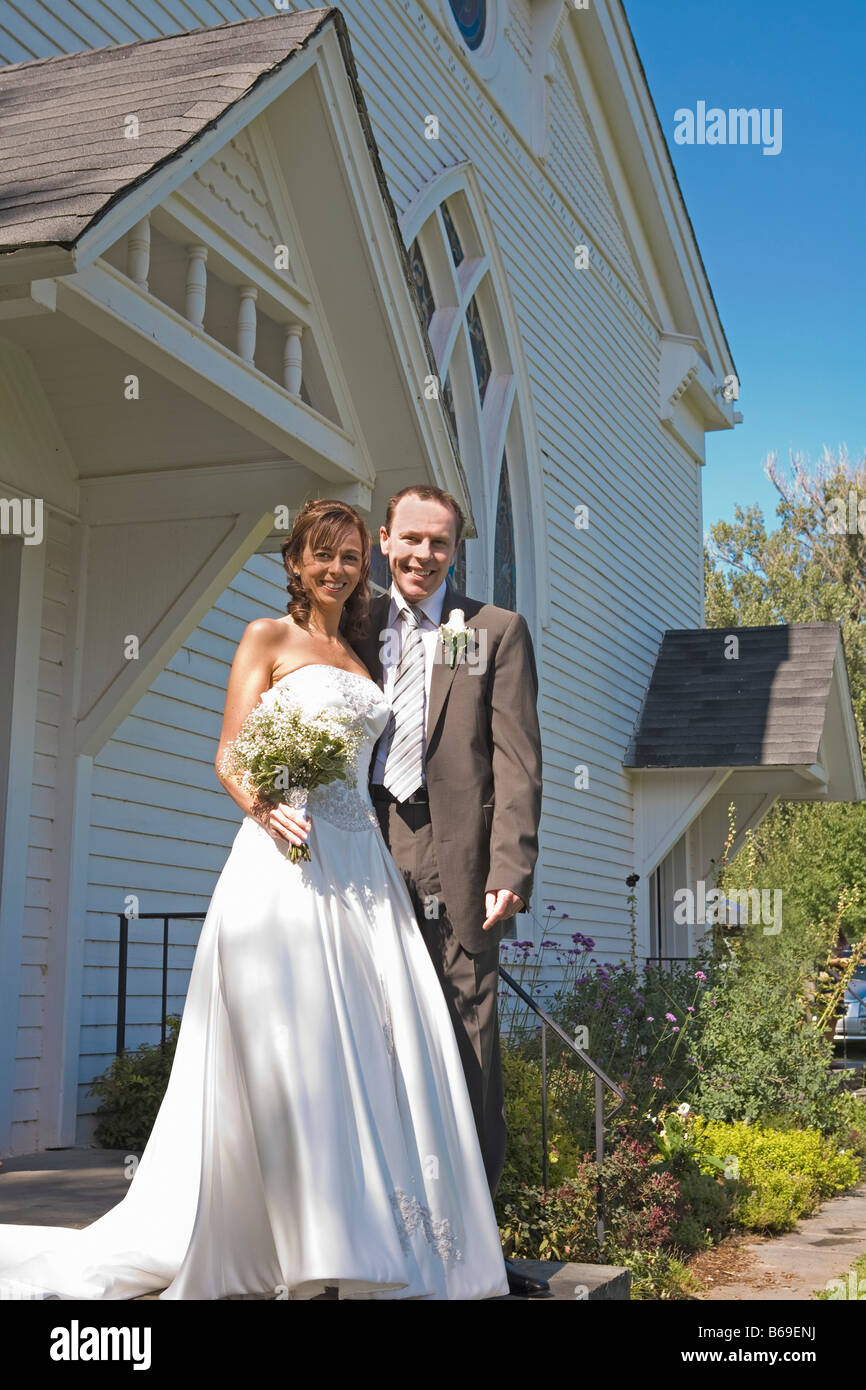 Newlywed couple standing in front of a church, East Meredith, New York