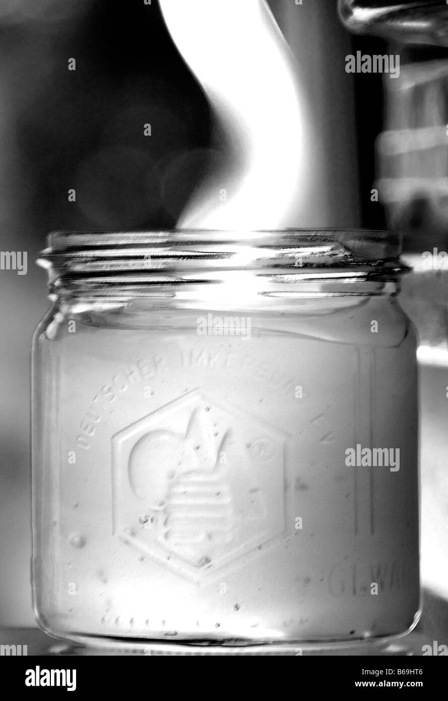 Filling a glass jar with homemade honey Stock Photo