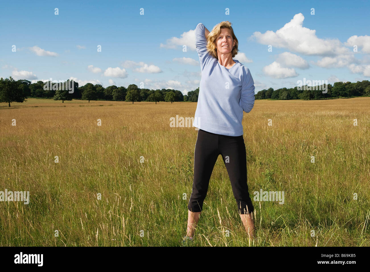 Woman stretching arms behind back Stock Photo Alamy