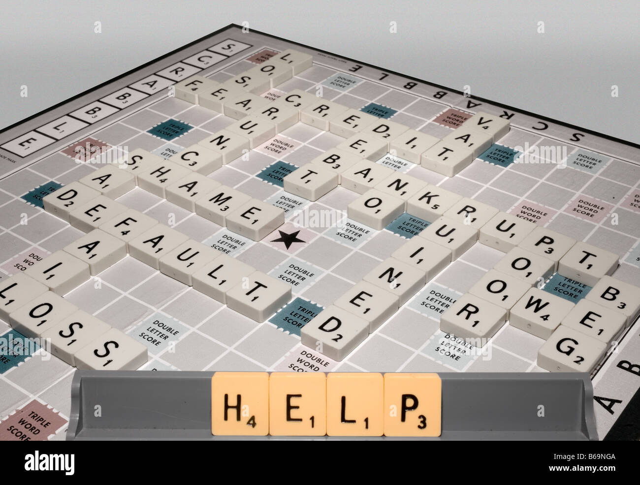 A scrabble game highlights global recession issues of the credit crunch and other financial implications and offers help Stock Photo