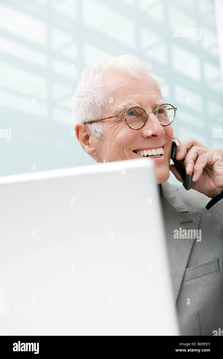 Older man using cell phone Stock Photo
