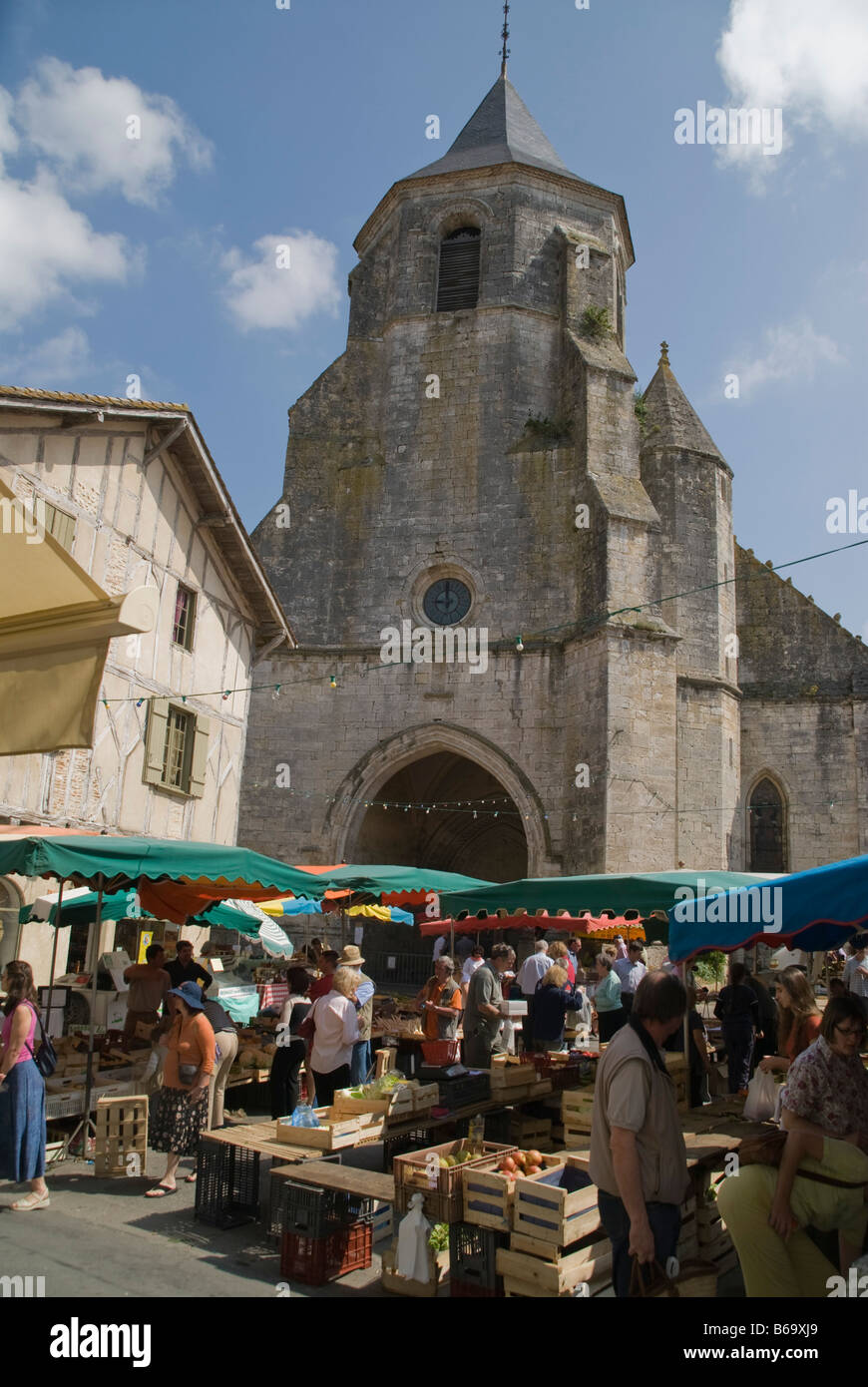 Church and French market stalls, France Stock Photo