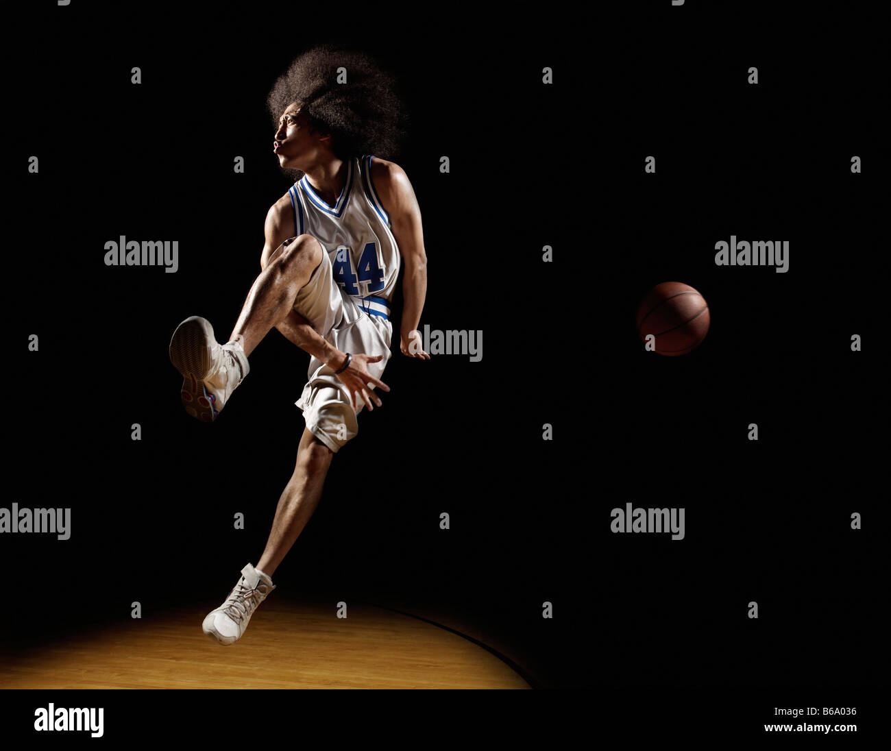 Mixed race basketball player passing basketball Stock Photo Alamy