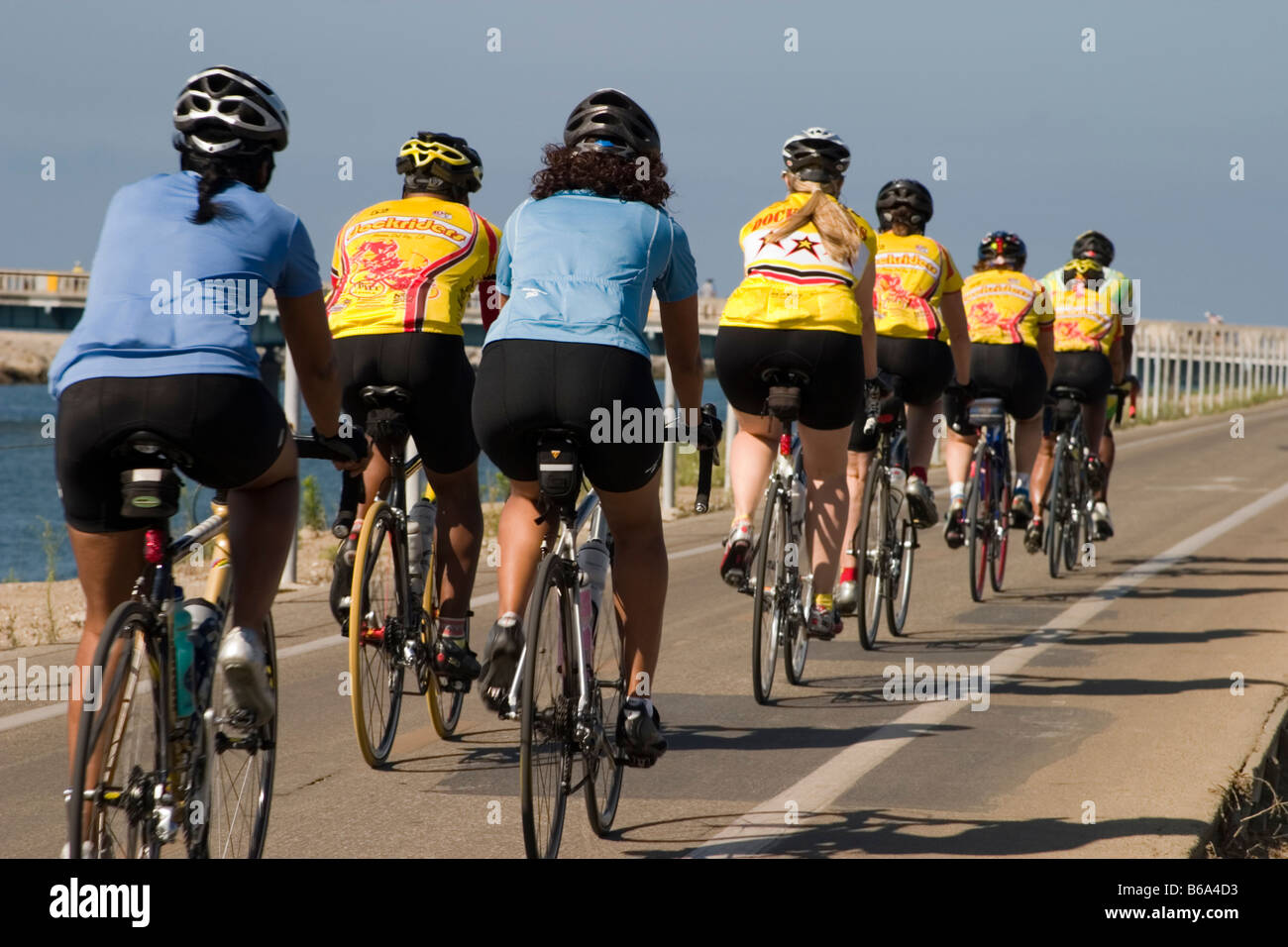 Pack of cyclists speeding by Stock Photo