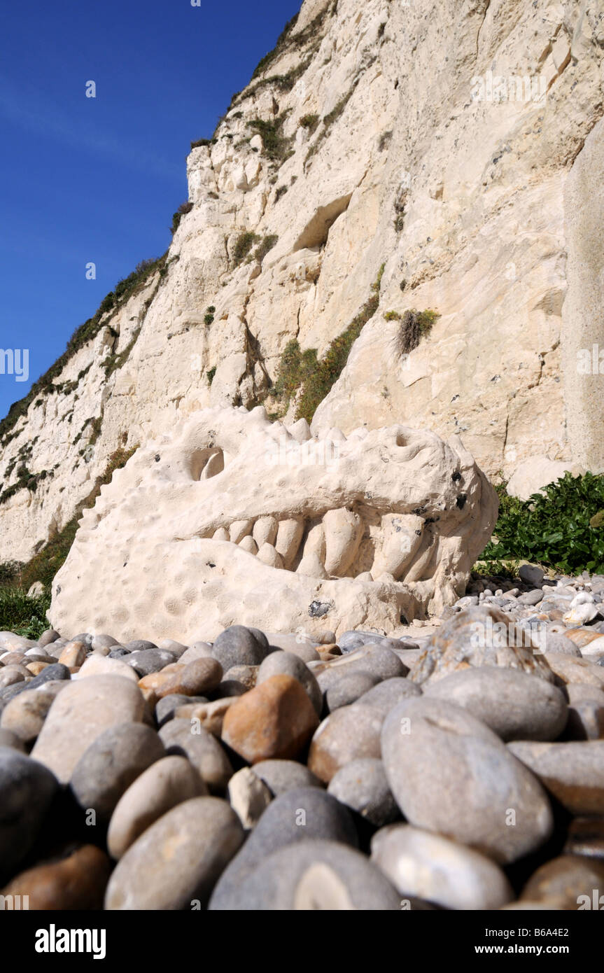 Dinosaur head carved in rock on the Jurassic Coast at Beer Devon UK Stock Photo