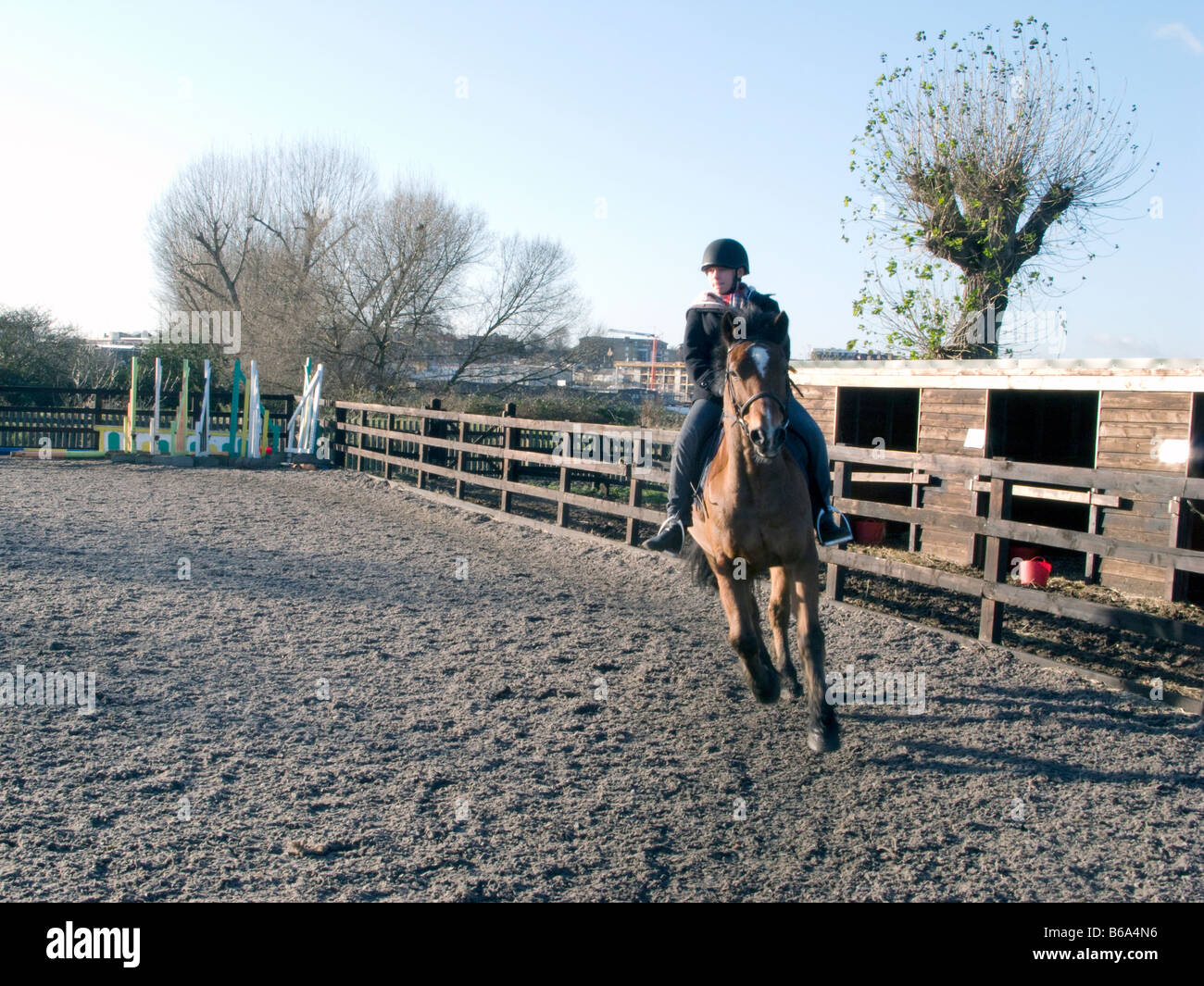 SCHOOL CHILDREN LEARNING TO RIDE AT A RIDING SCHOOL LONDON, UK. Photo ...