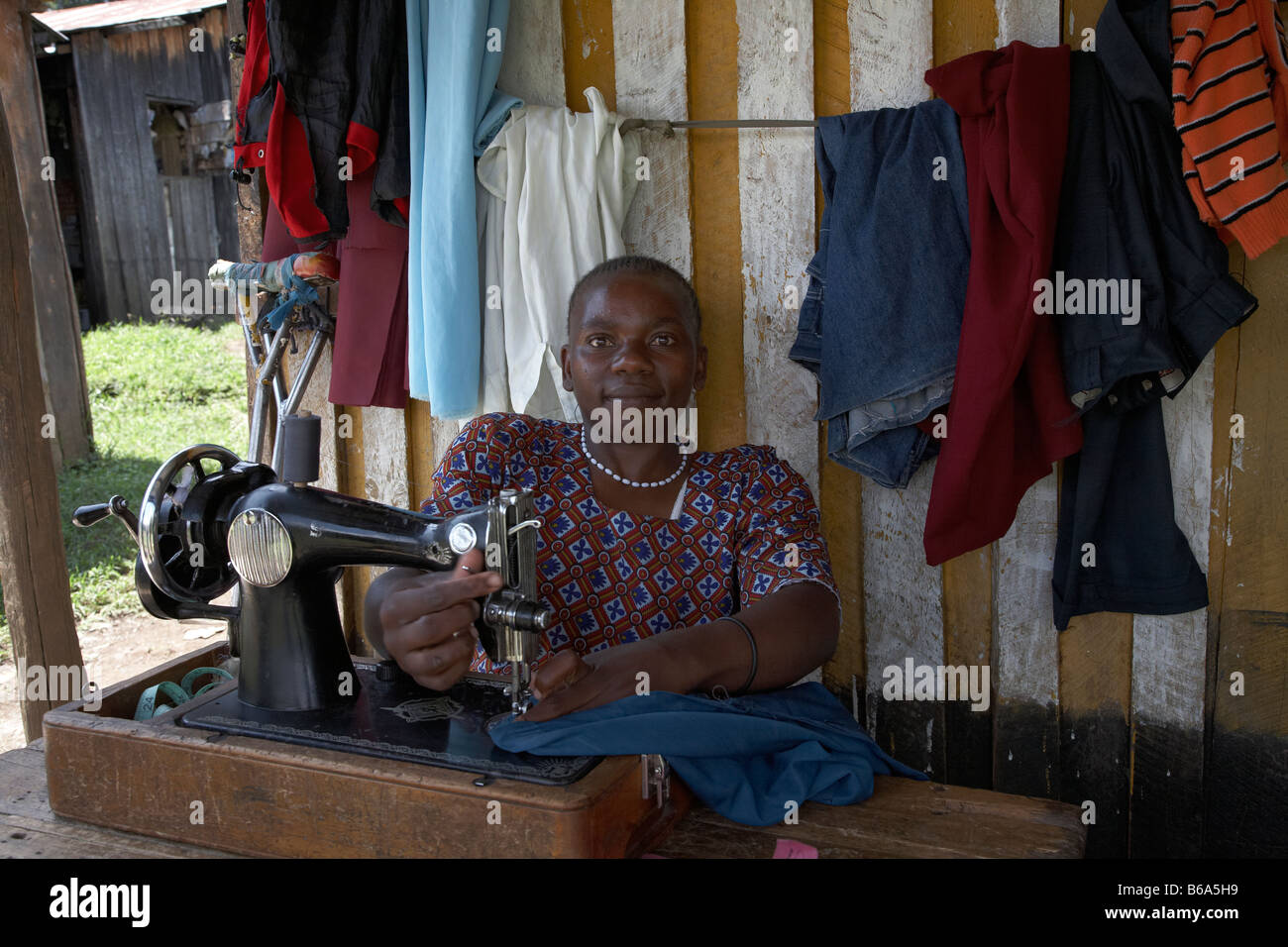Kenyan lady on sewing machine Stock Photo Alamy