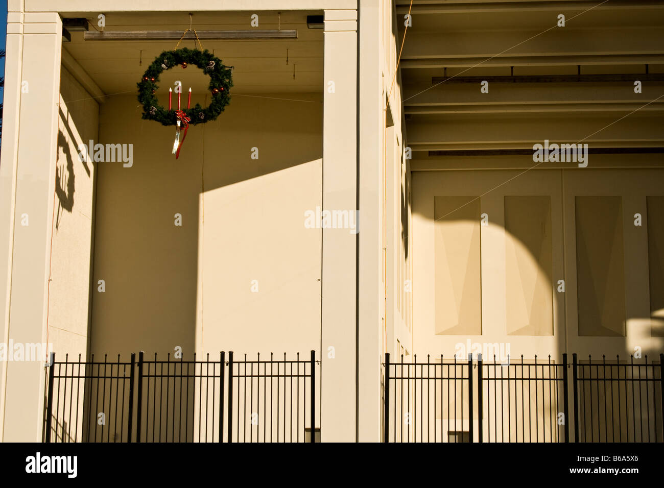 Christmas wreath with three candles on the side of an amphitheater hanging from the ceiling. Stock Photo