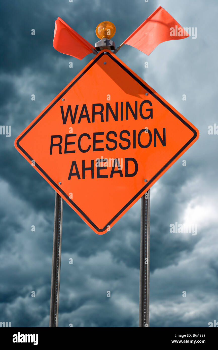 An orange highway safety sign with the words 'Warning Recession Ahead' on it Stock Photo