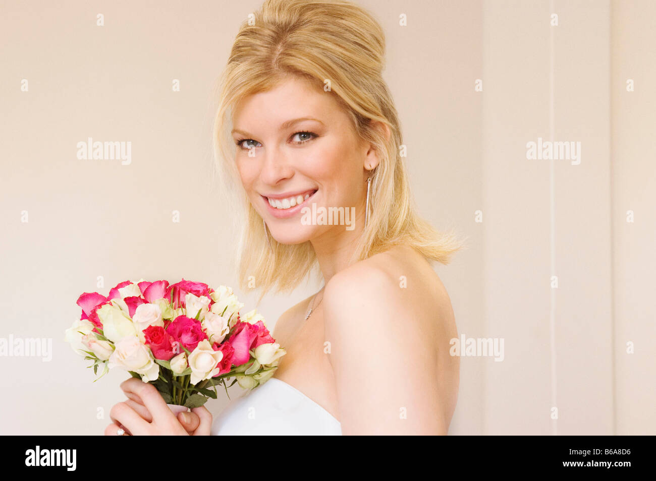 Bride holding bouquet smiling hi-res stock photography and images - Alamy