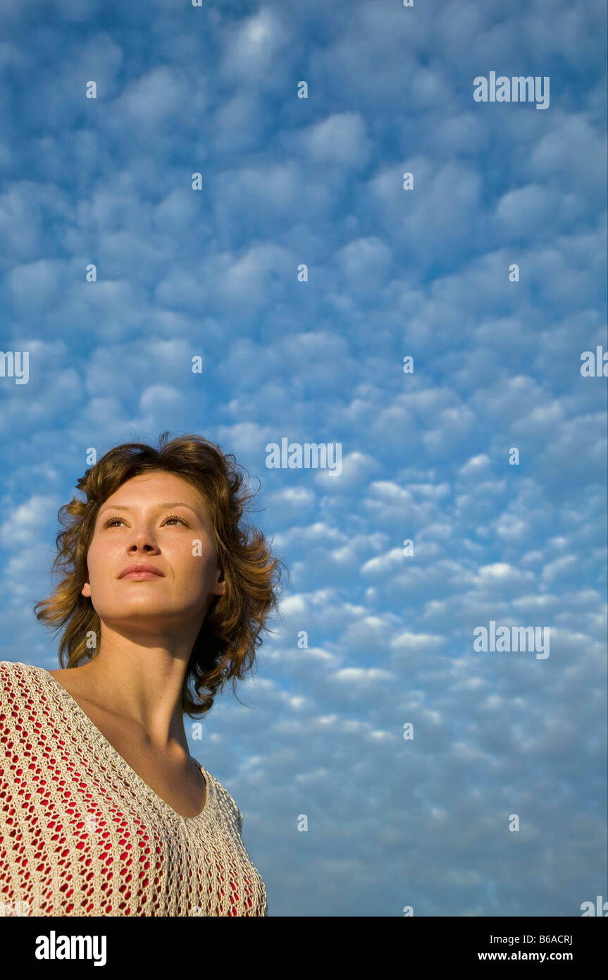 Woman and clouds in a blue sky Stock Photo - Alamy