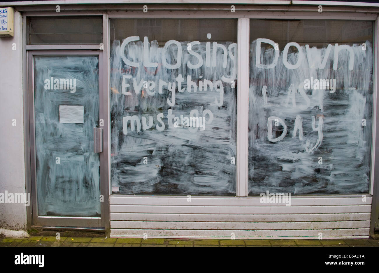 Closed shop with whitewashed windows in Abertillery Blaenau Gwent South Wales UK Stock Photo