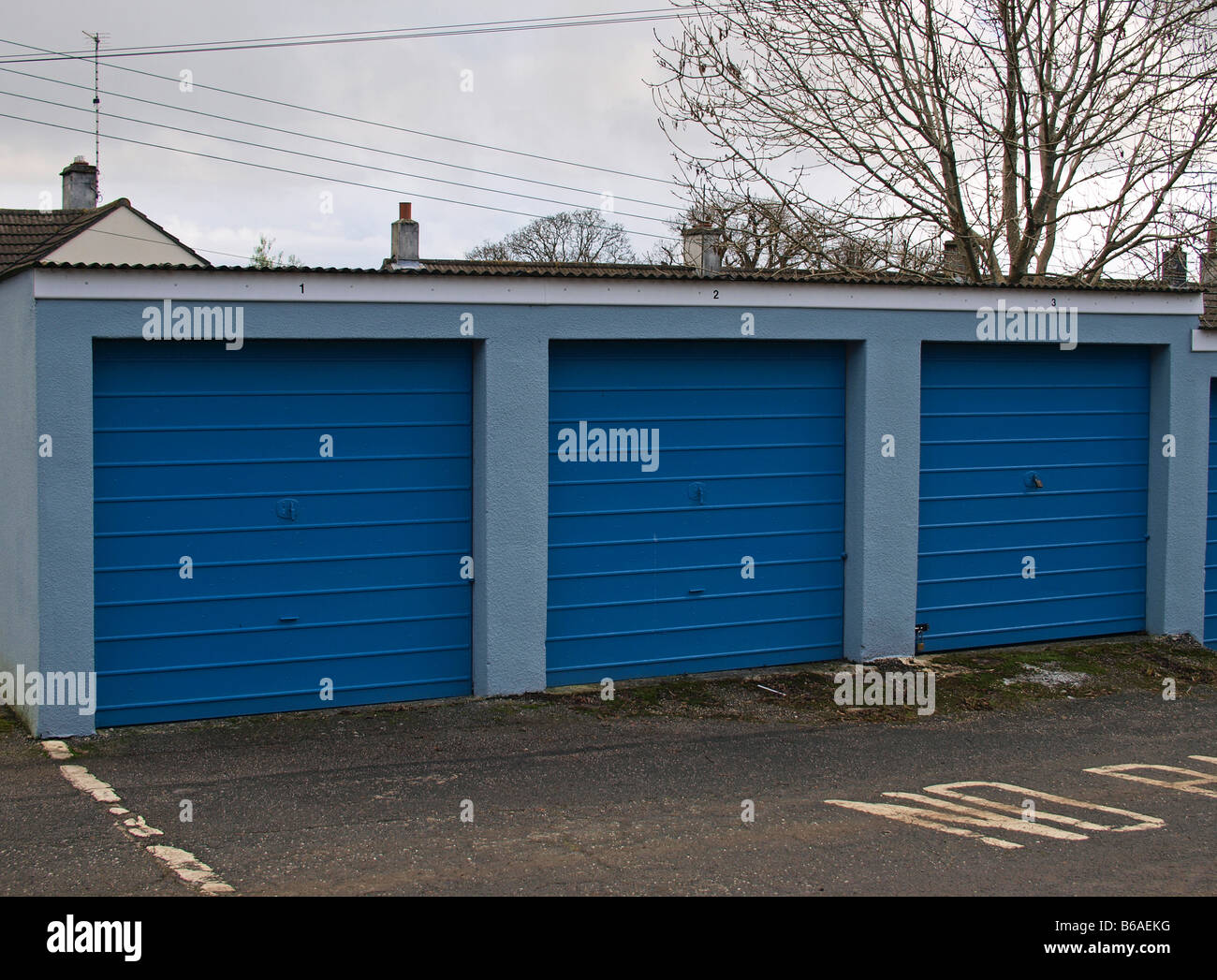 a row of three blue garages Stock Photo