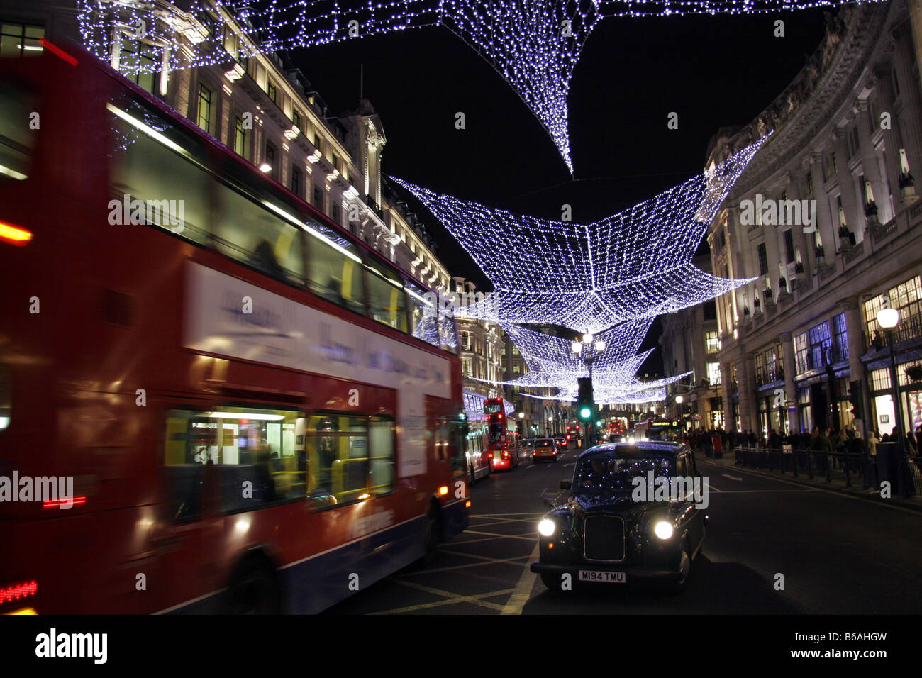 Christmas lights with taxi and double decker bus in Regents Street