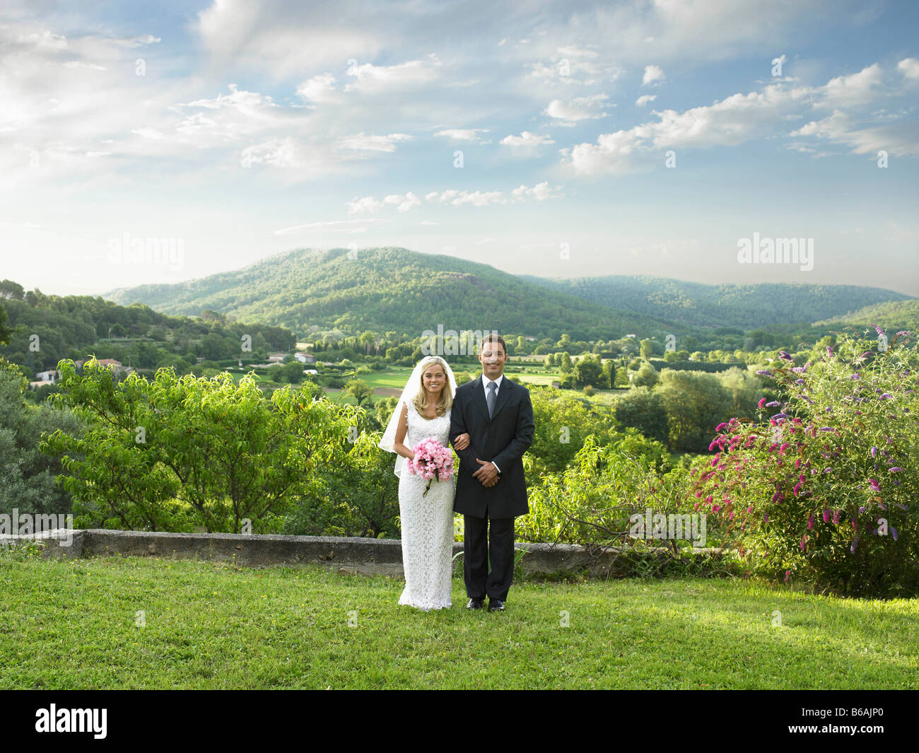 Wedding couple in sunlit garden Stock Photo