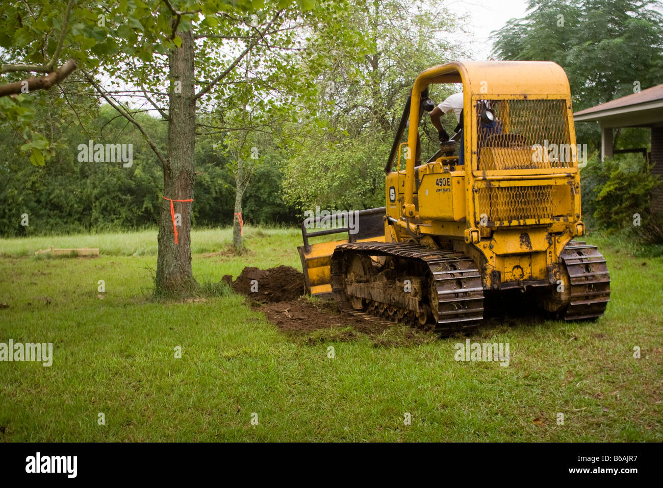 Bulldozer prepairs foundation for home construction project Stock Photo