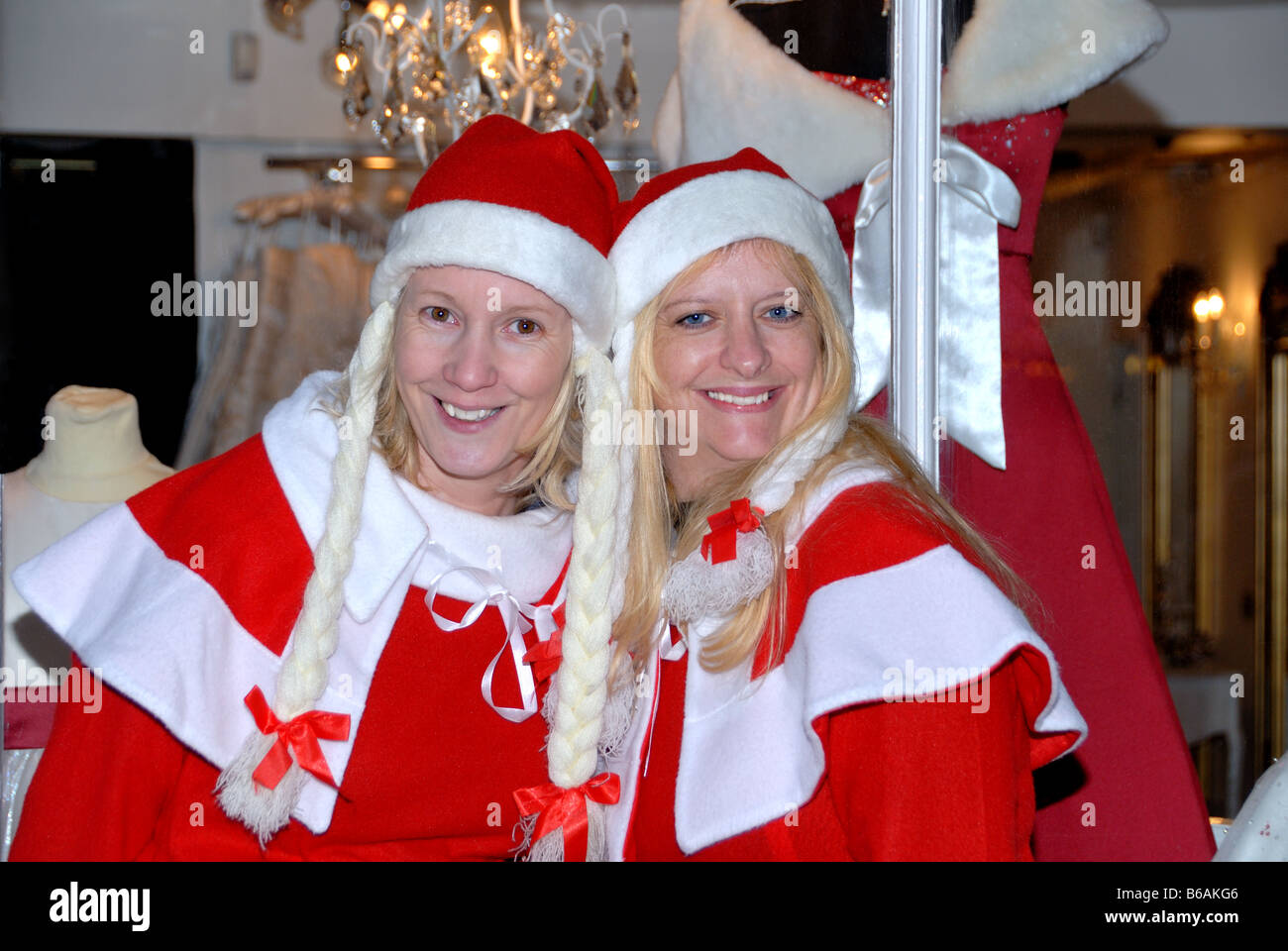 Two girls dressed as santa claus Rochester Victorian festival Stock Photo