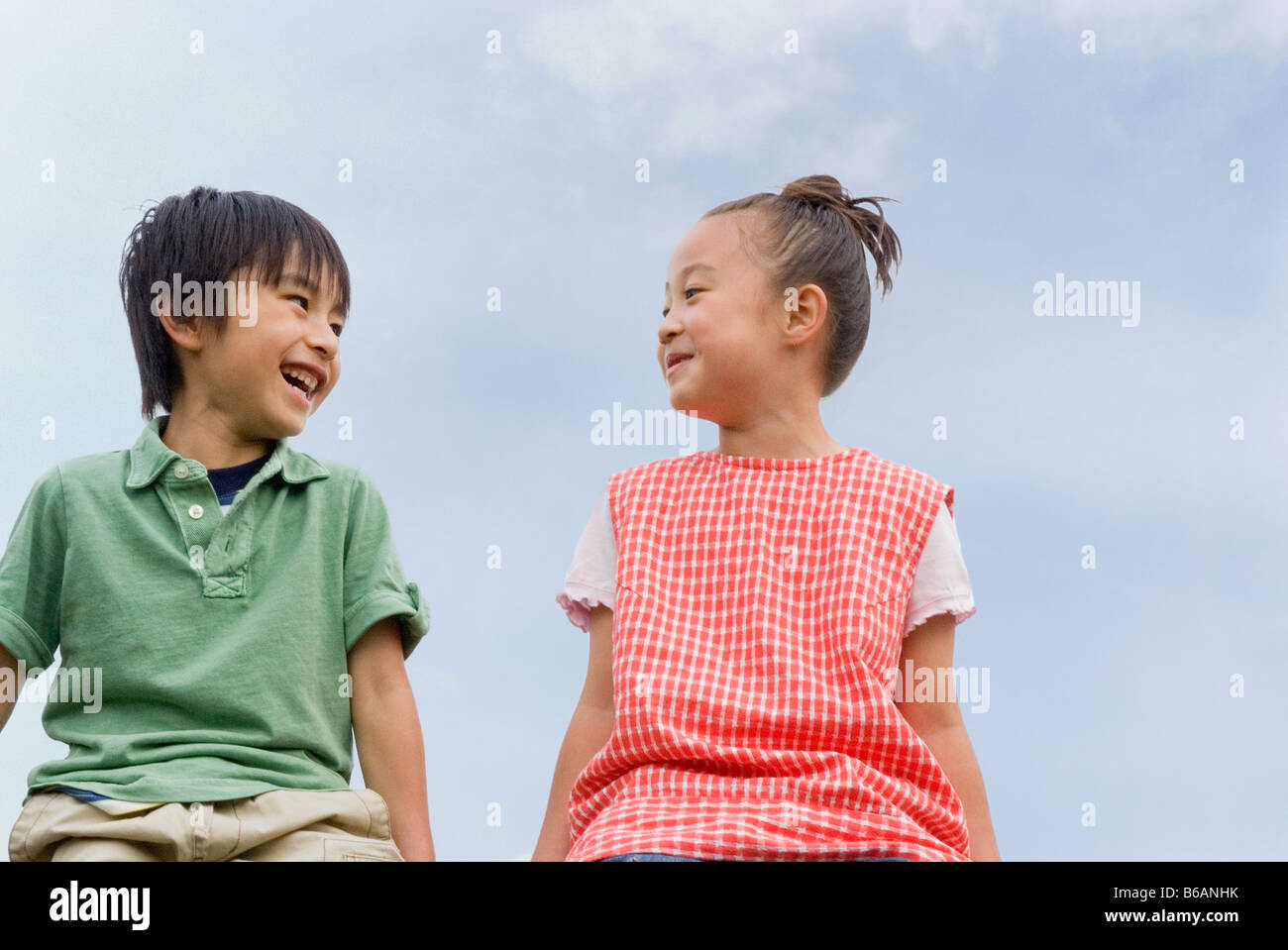 Boy and girl looking at each other Stock Photo - Alamy