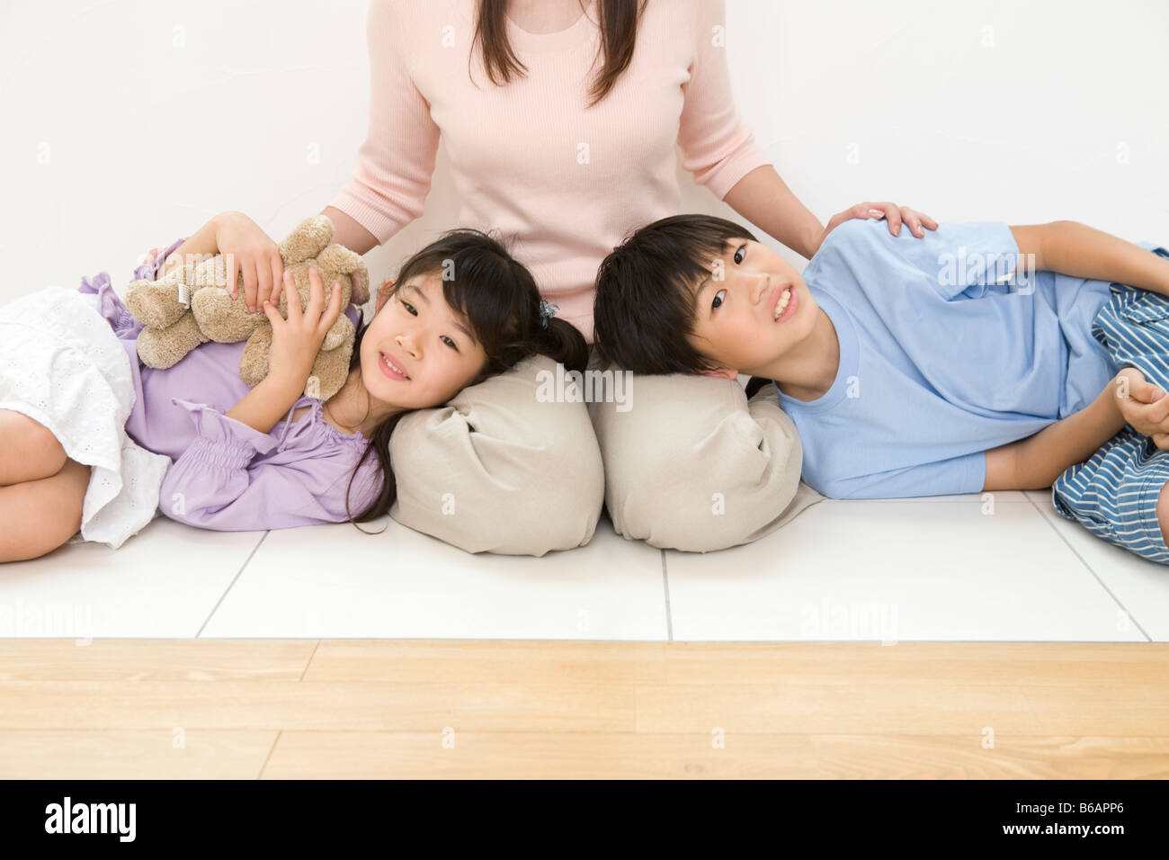 Children sleeping on mother's lap Stock Photo Alamy