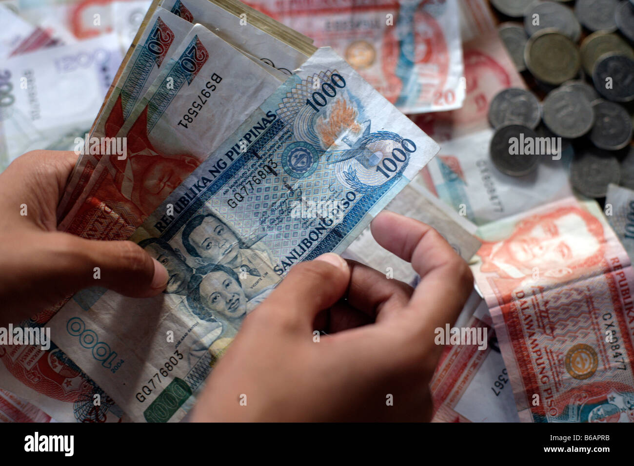 Philippine peso notes and coins are displayed in Manila Stock Photo
