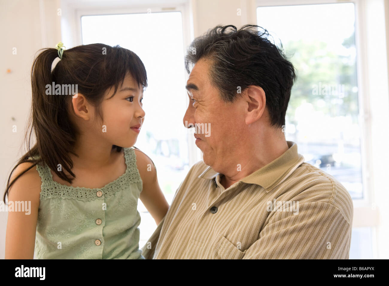 Grandfather starting at granddaughter Stock Photo