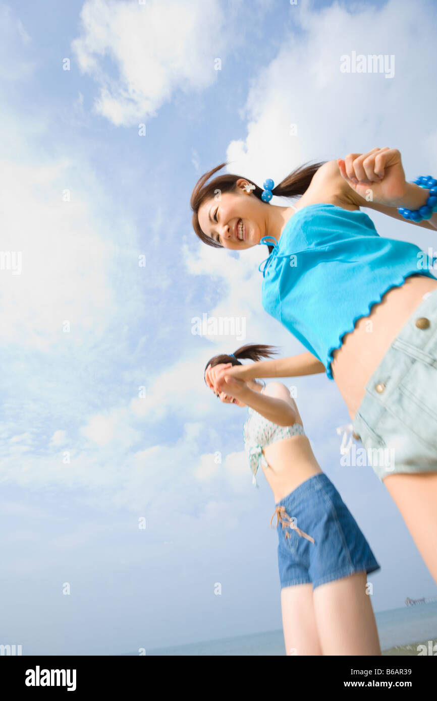 Two young women walking at beach Stock Photo - Alamy