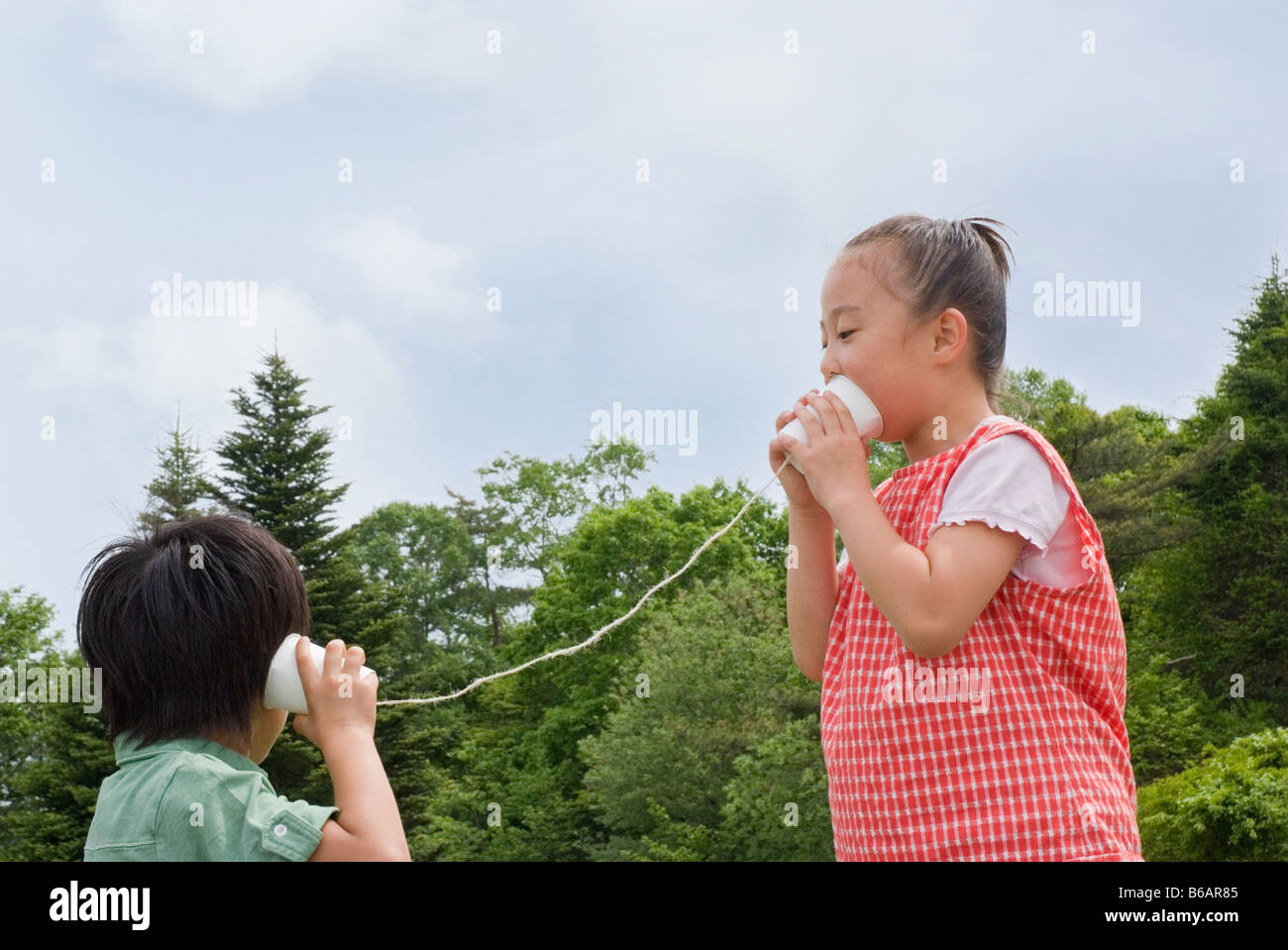 Boy girl talking string telephone hires stock photography and images