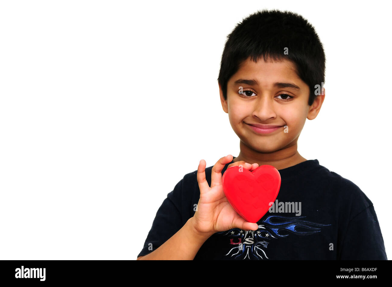 Handsome young Indian boy holding a red heart Stock Photo
