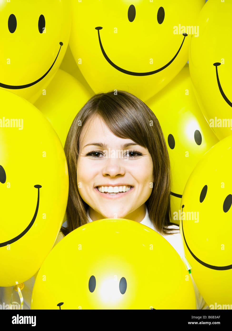 woman with smiley face balloons Stock Photo