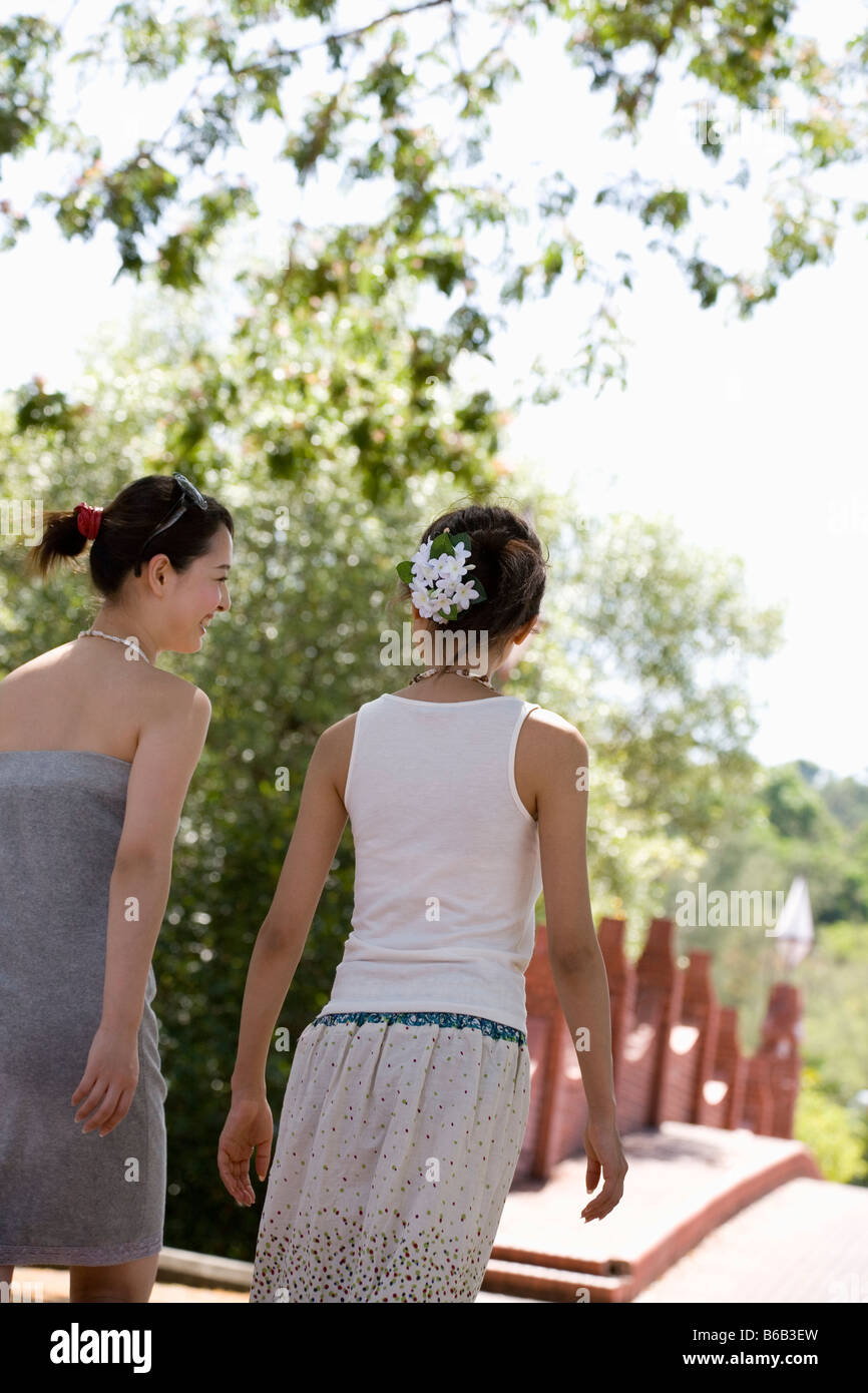 Two young women walking Stock Photo - Alamy