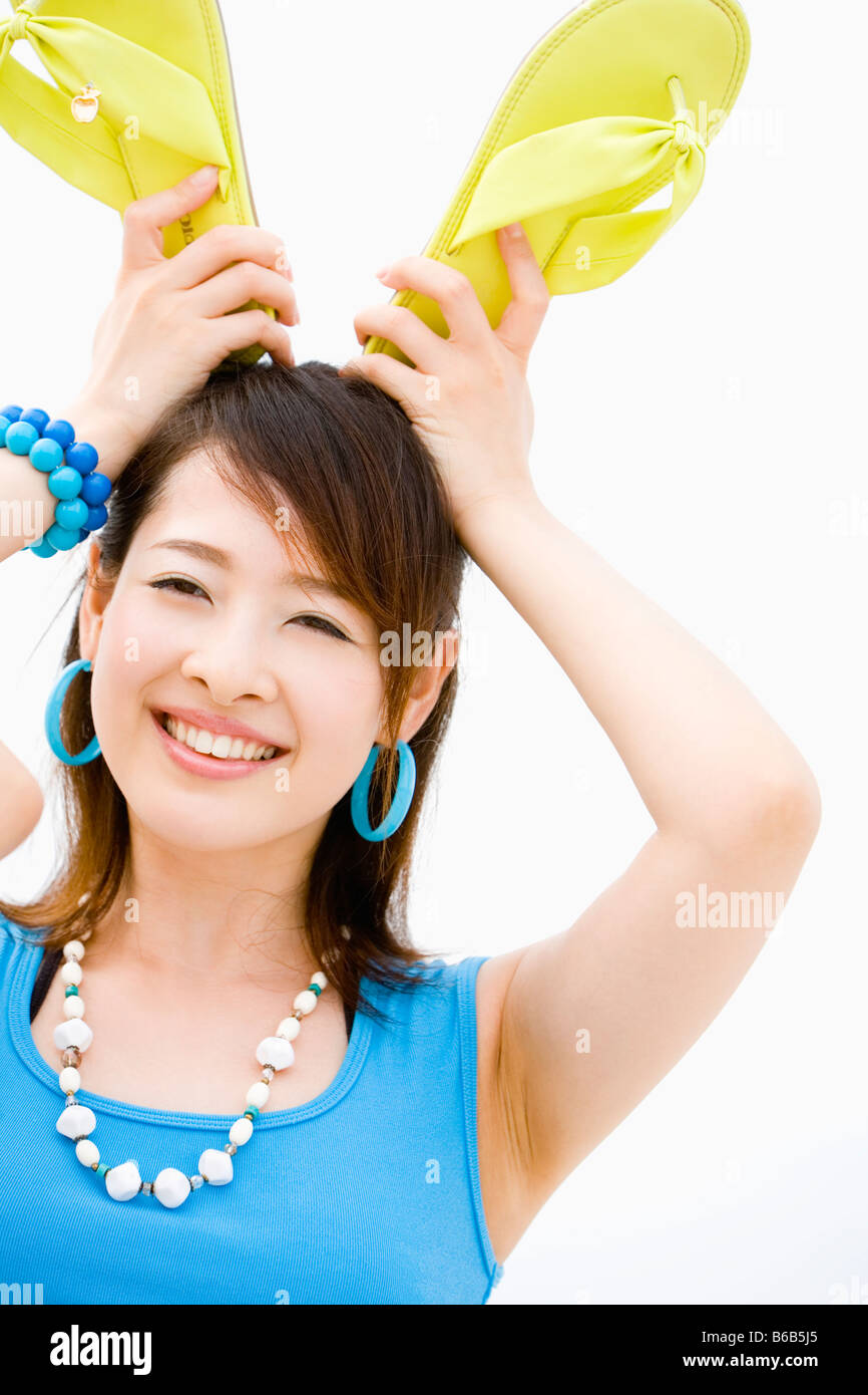 Young woman standing at beach Stock Photo - Alamy