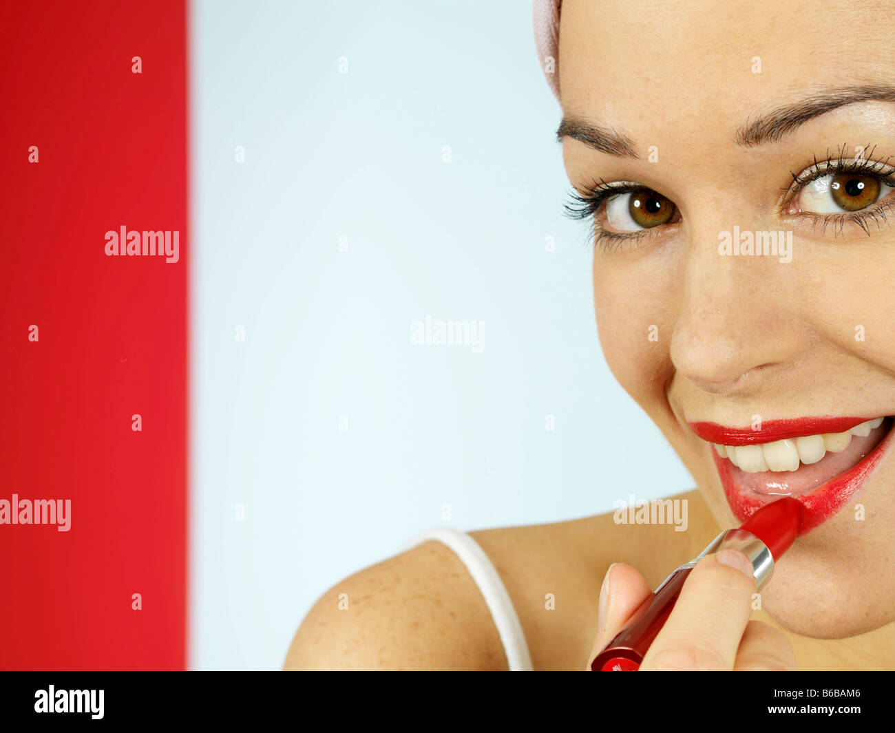 Young Woman Applying Red Lipstick Model Released Stock Photo