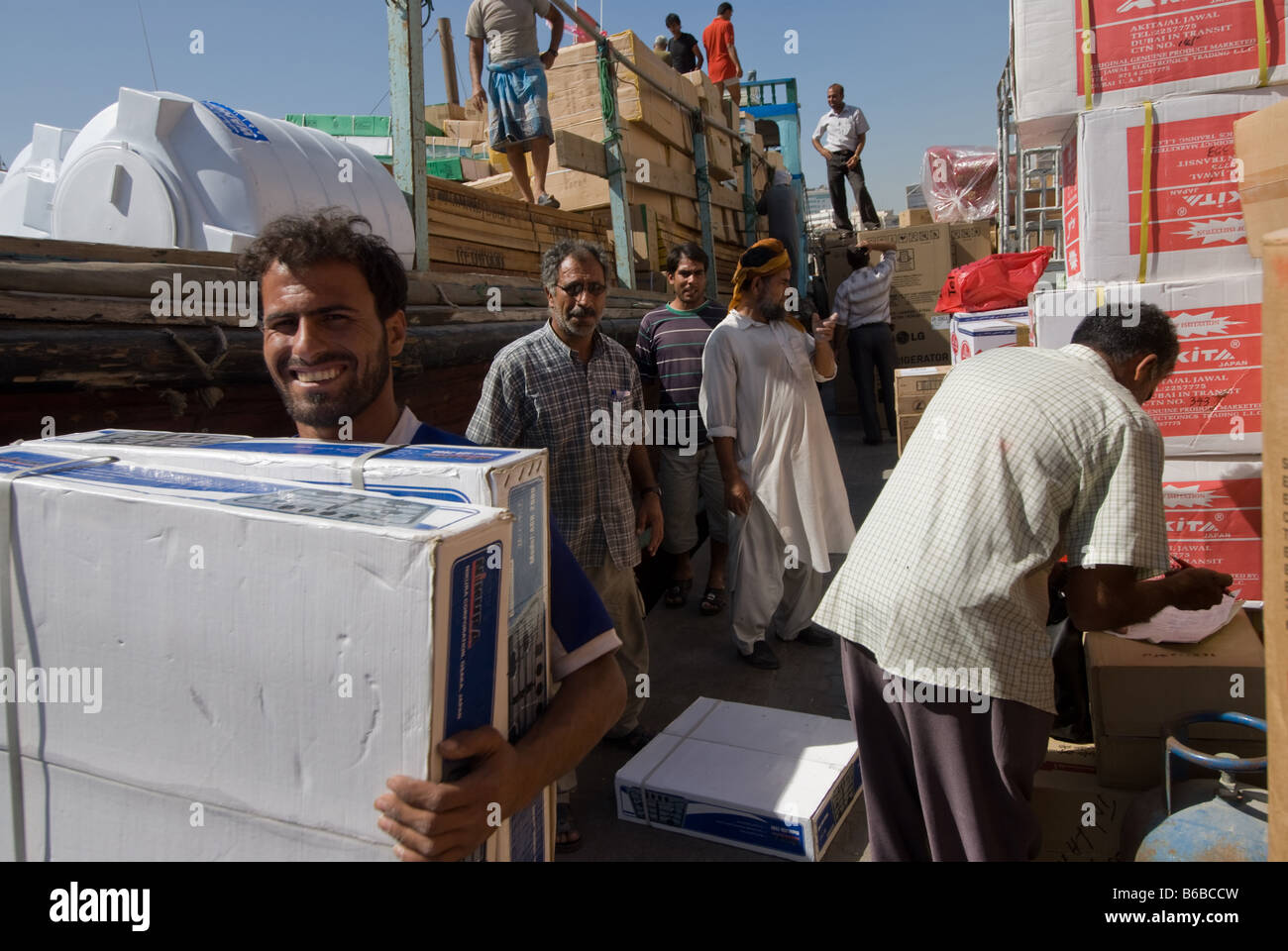 A worker in Dubai Creek loading goods on ships Iran bound that same