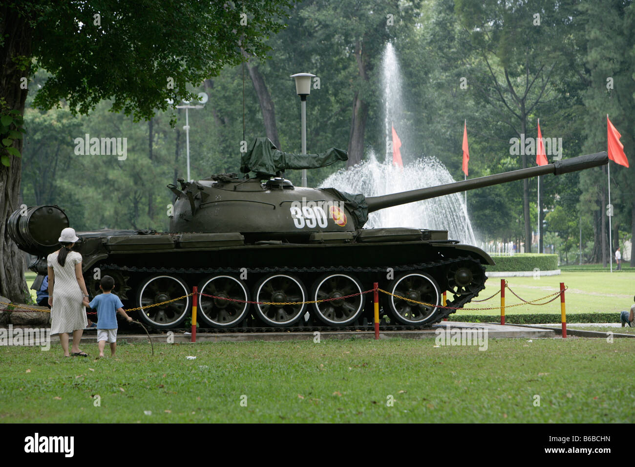 Tank Walk People walk infront of a tank that is parked at the Unification Palace ...