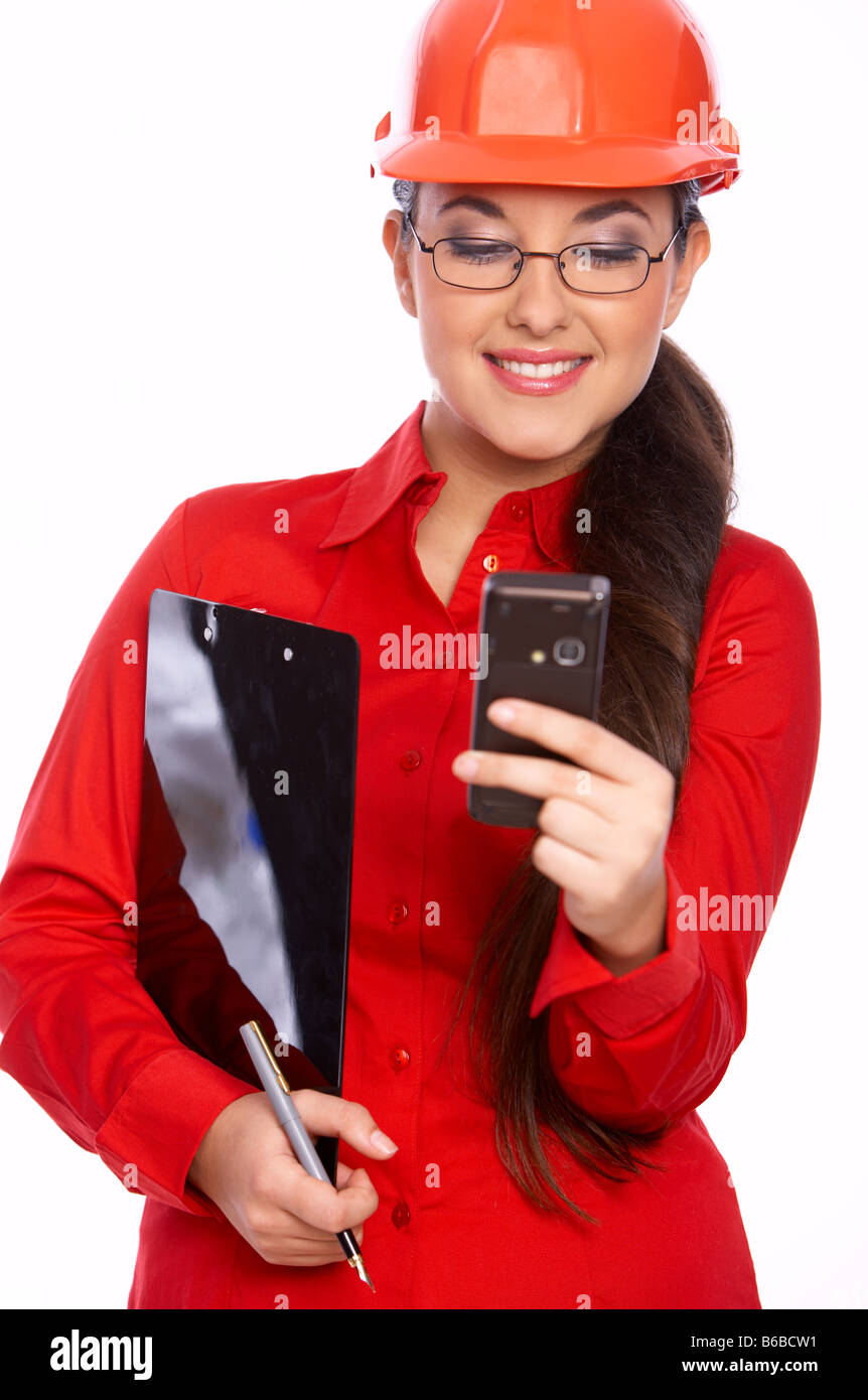 Female architect holding clipboard using cell phone Stock Photo Alamy