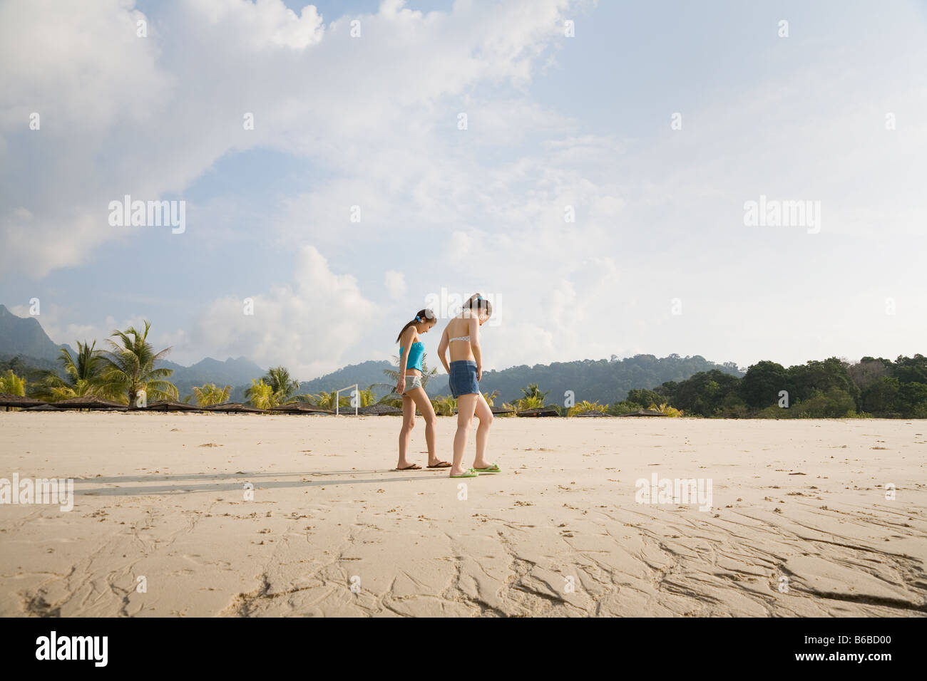 Two young women walking at beach Stock Photo - Alamy