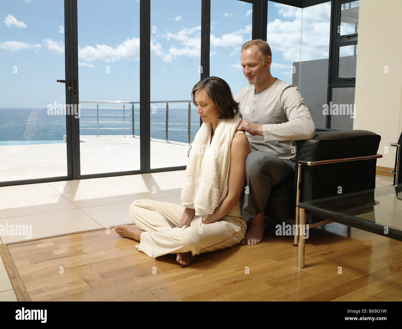 Man massaging her wife's shoulders Stock Photo