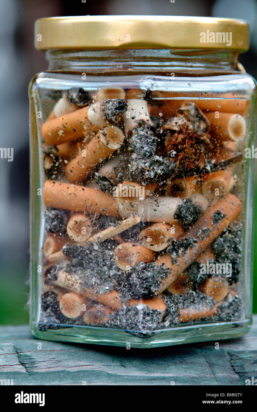 Close-up of jar of cigarette butts Stock Photo