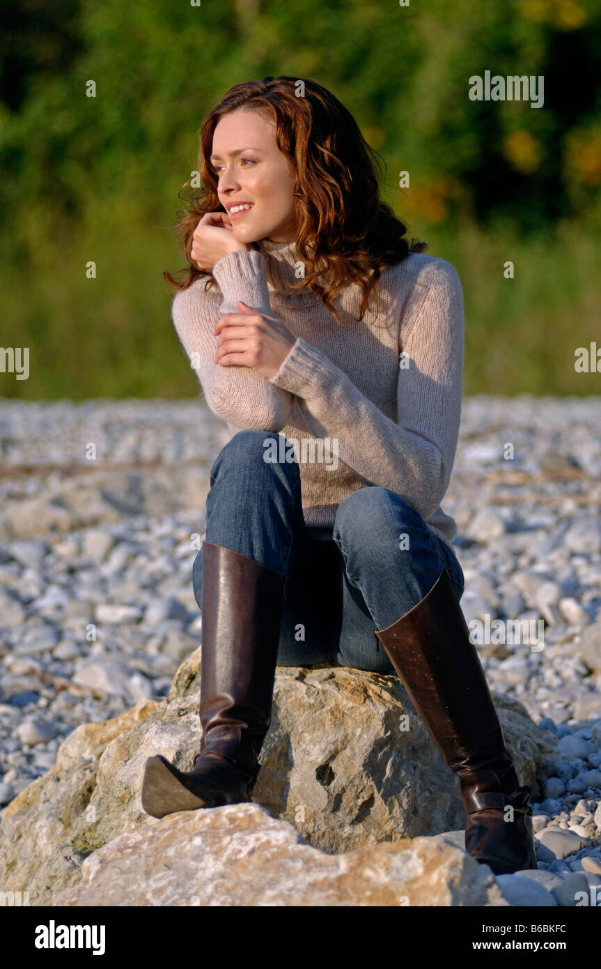 Person sitting on rock hi-res stock photography and images - Alamy