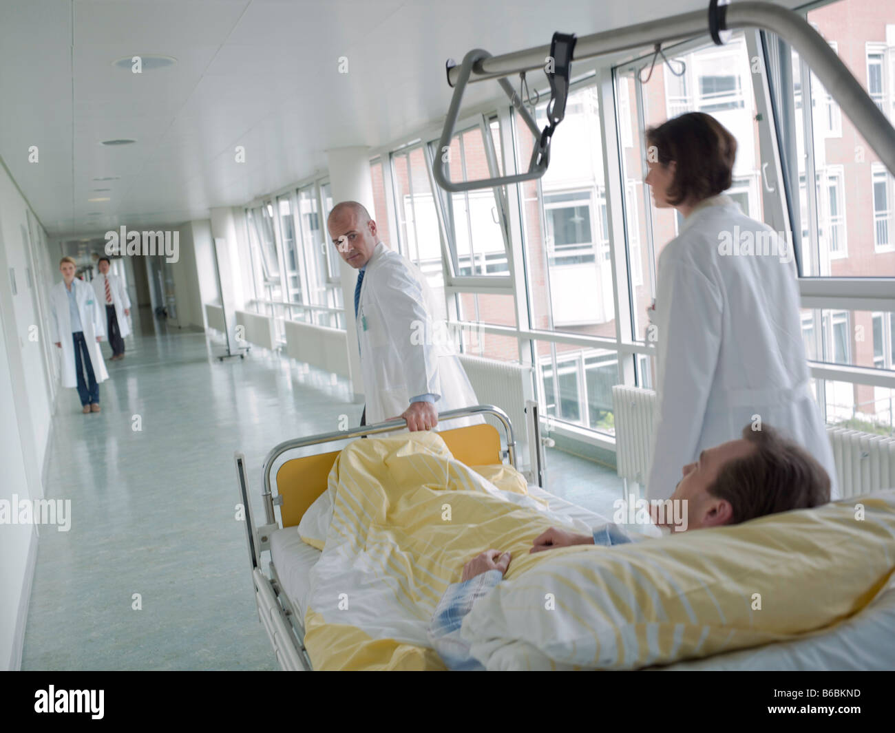 Doctor pulling patient on gurney Stock Photo Alamy