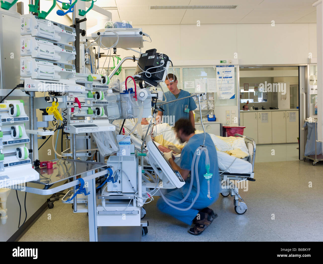 Two male doctors examining patient Stock Photo - Alamy