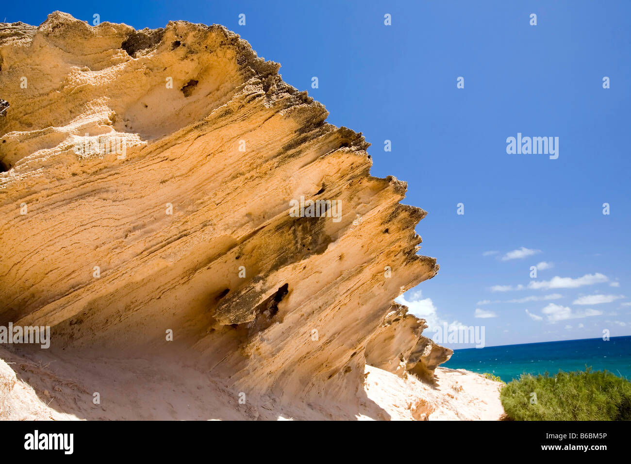 Jagged sandy rocks created by the oceans tides. Stock Photo