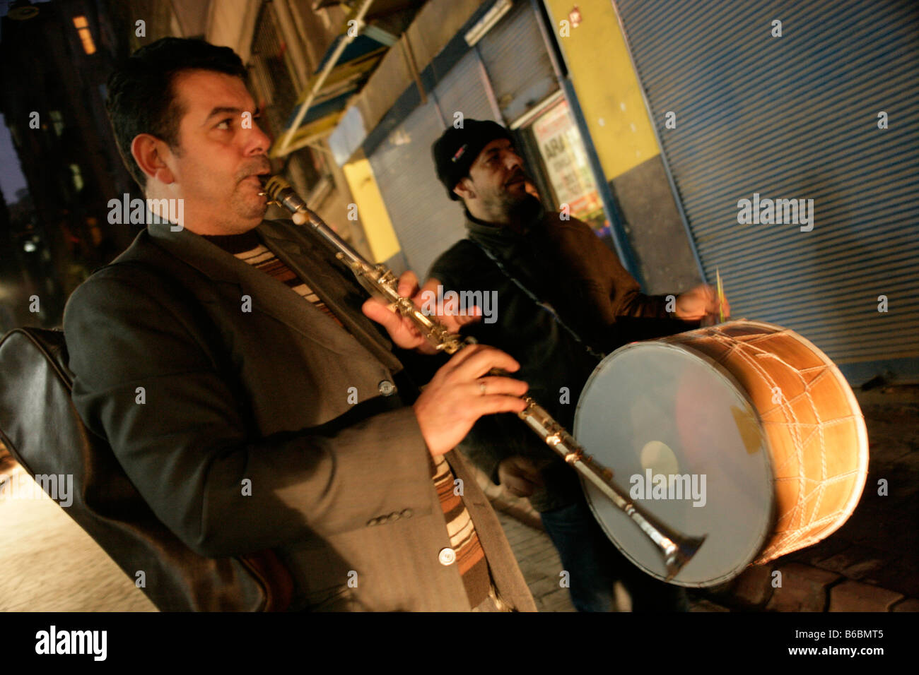 Roma gypsy musicians play for a wedding party in a Beyoglu street, Istanbul, Turkey. The musicians play the zurna and davul drum Stock Photo
