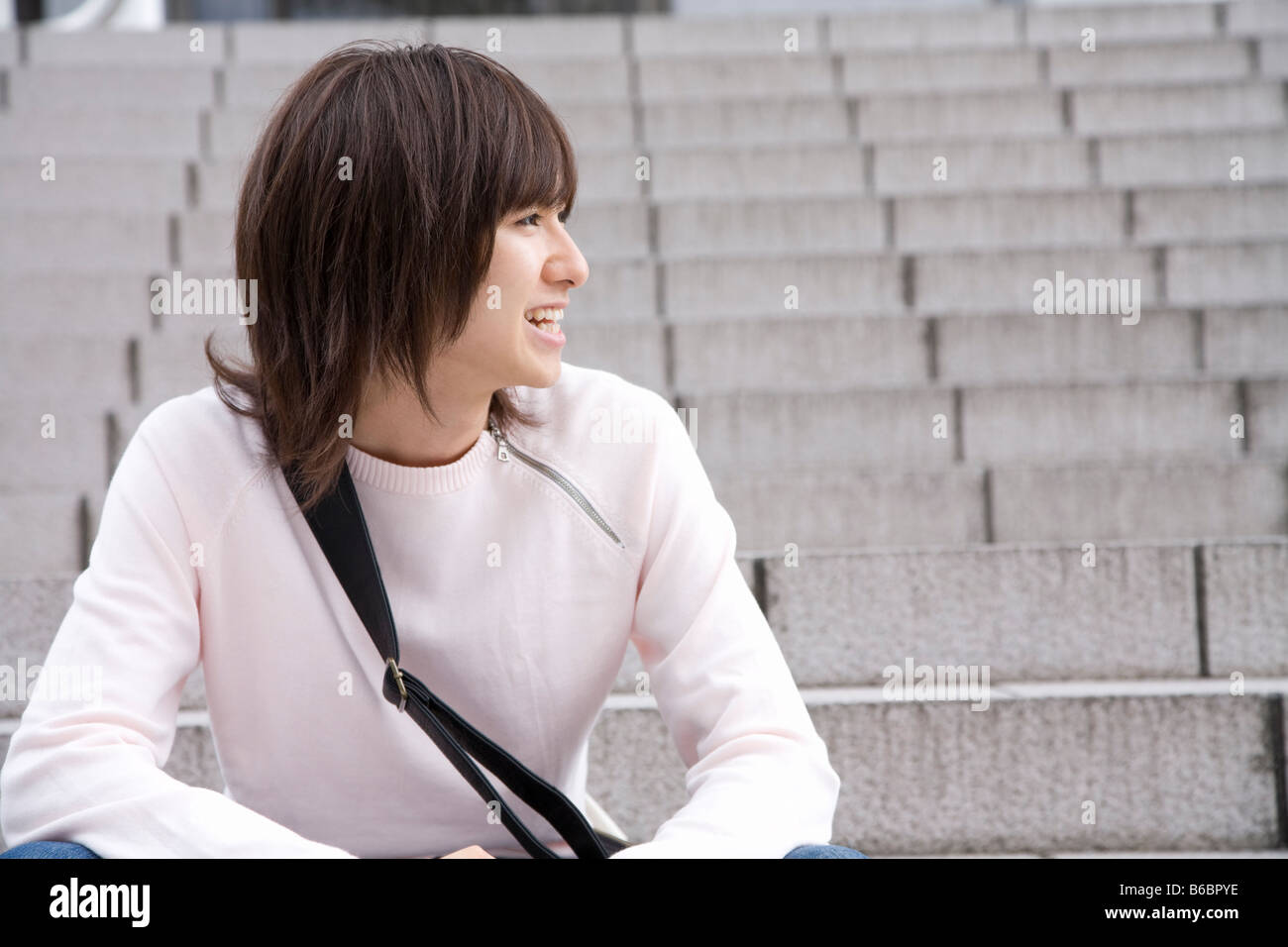 Young man sitting on steps Stock Photo - Alamy