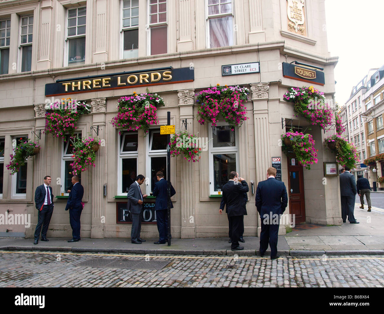Three lords pub people drinking and smoking outdoors St Clare street London city Stock Photo