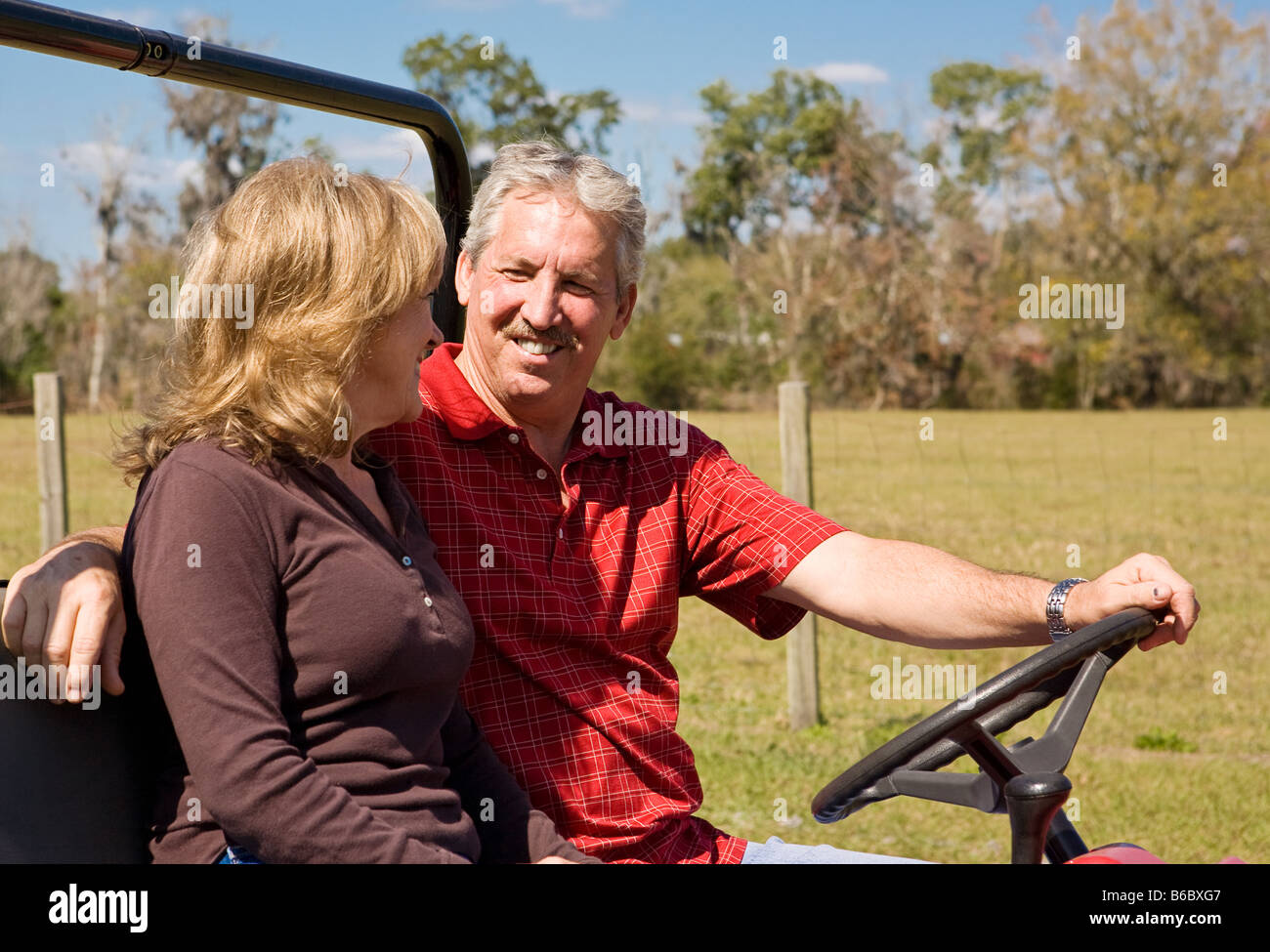 Retired middle aged couple having fun outdoors together Room for text Stock Photo