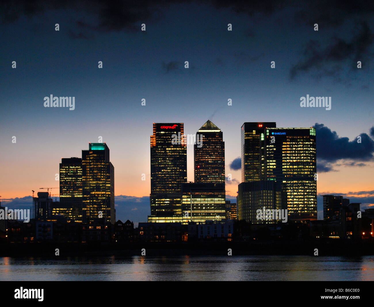 Canary Wharf skyline at sunset shot from across the Thames river dusk ...